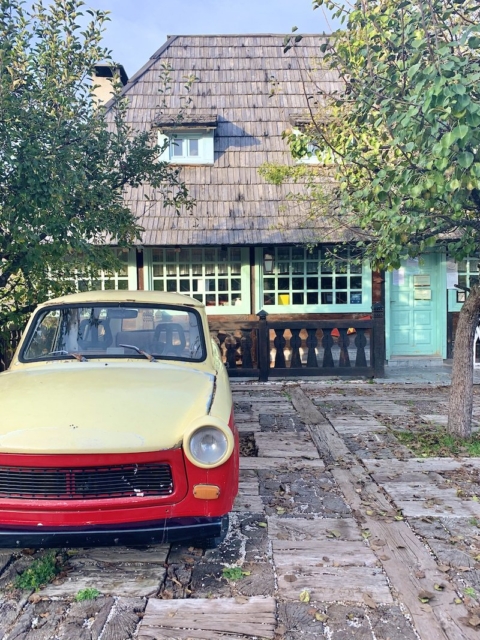 Drvengrad retro car in front of house 